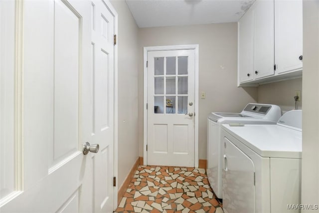 laundry area with washer and clothes dryer, cabinet space, and baseboards