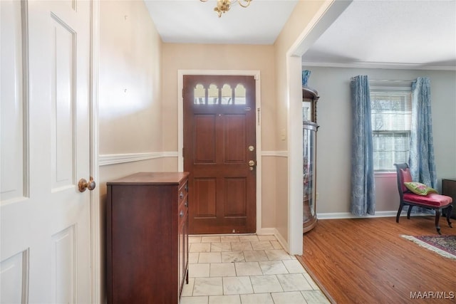 foyer entrance featuring light wood-type flooring and baseboards