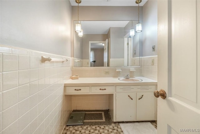 bathroom with tile walls, wainscoting, and vanity