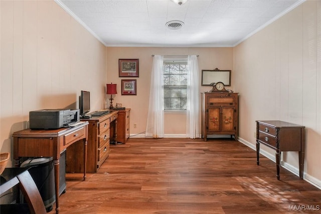 office area with visible vents, baseboards, wood finished floors, and crown molding