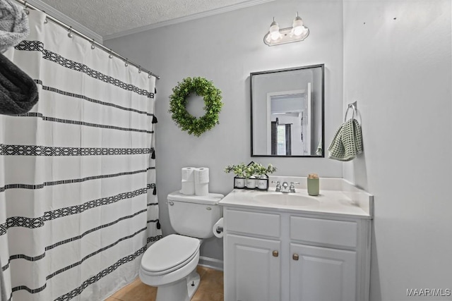 full bathroom with toilet, vanity, ornamental molding, tile patterned floors, and a textured ceiling