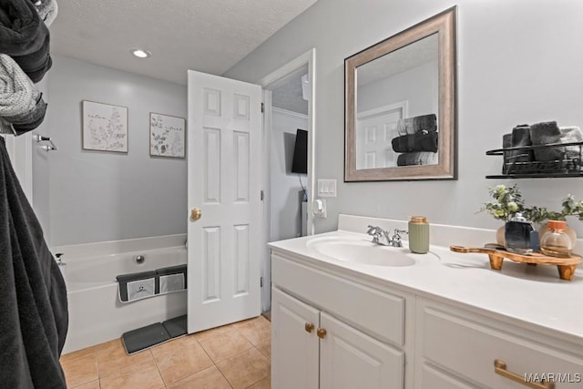 full bath with vanity, recessed lighting, a textured ceiling, tile patterned floors, and a bathtub