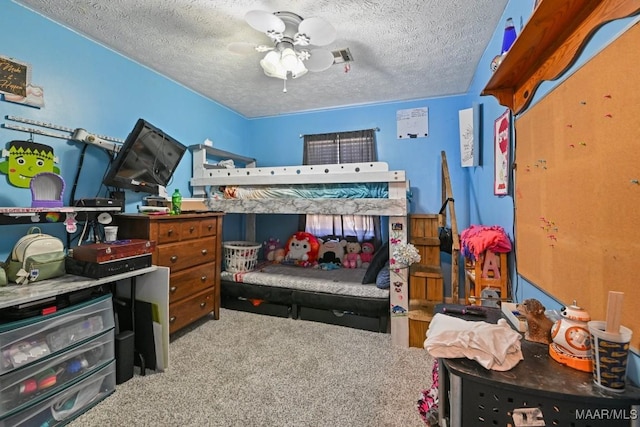 bedroom featuring visible vents, carpet floors, and a textured ceiling