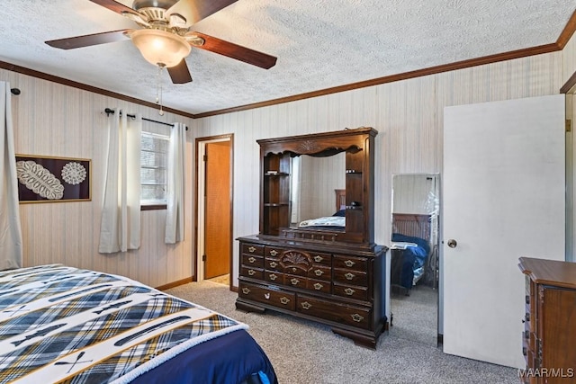 carpeted bedroom featuring wallpapered walls, crown molding, and a textured ceiling