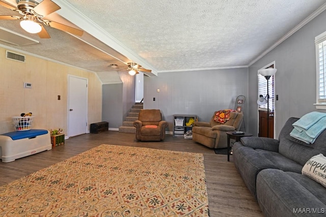 living area featuring visible vents, crown molding, stairs, and wood finished floors