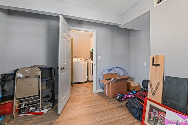 interior space featuring visible vents, wood finished floors, and separate washer and dryer