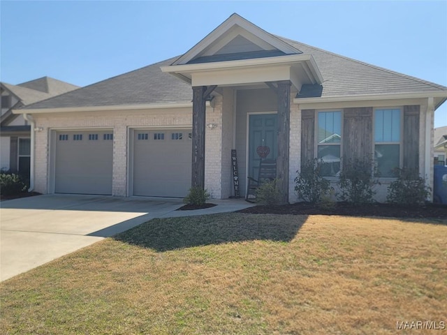 view of front of property with driveway, a front yard, a shingled roof, a garage, and brick siding