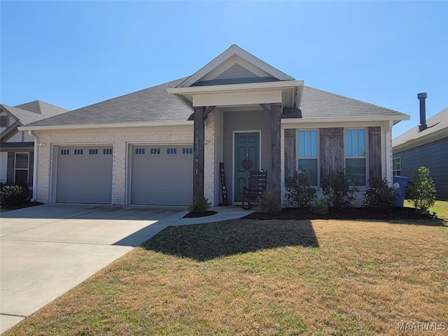 view of front of home with brick siding, an attached garage, driveway, and a front yard