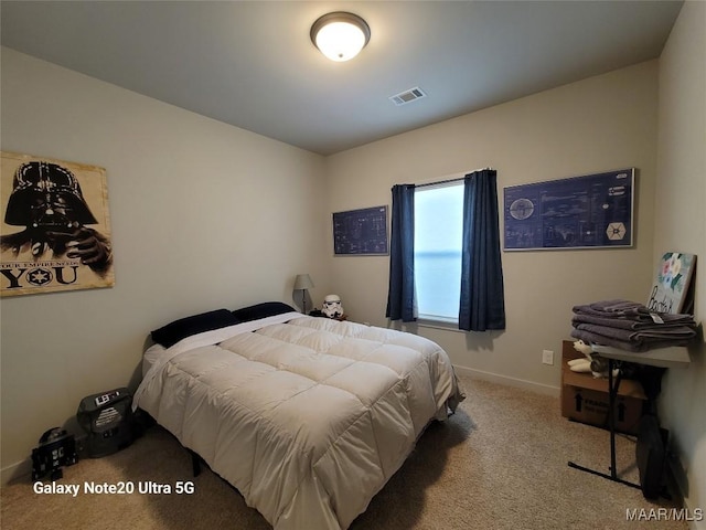 carpeted bedroom with visible vents and baseboards