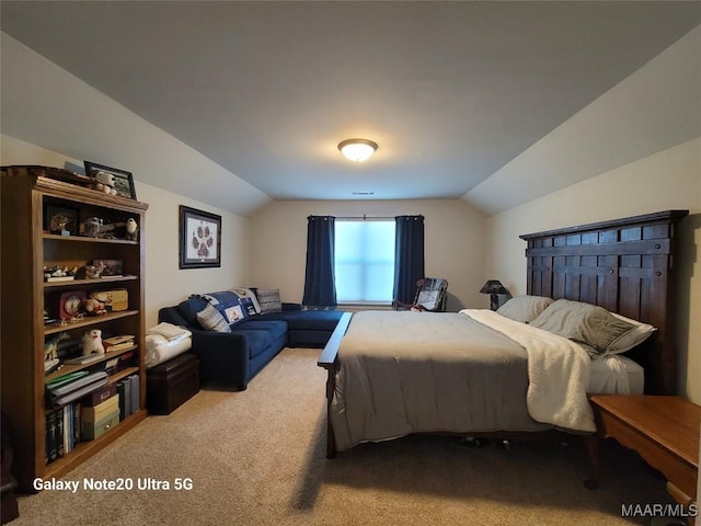 carpeted bedroom with lofted ceiling