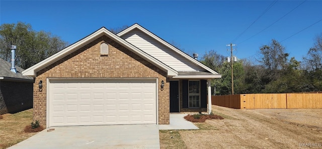 view of front of house with brick siding, fence, concrete driveway, a garage, and a gate