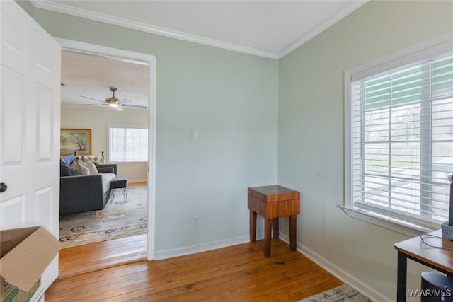 interior space featuring hardwood / wood-style floors, baseboards, ornamental molding, and ceiling fan