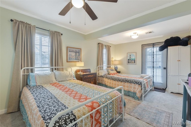 carpeted bedroom with crown molding, multiple windows, a ceiling fan, and visible vents