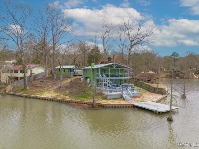 view of dock featuring a deck with water view and fence