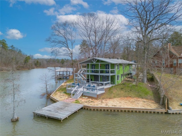 view of dock featuring a deck with water view and stairs