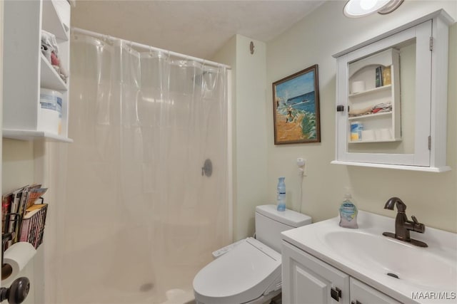 bathroom featuring vanity, toilet, and a stall shower