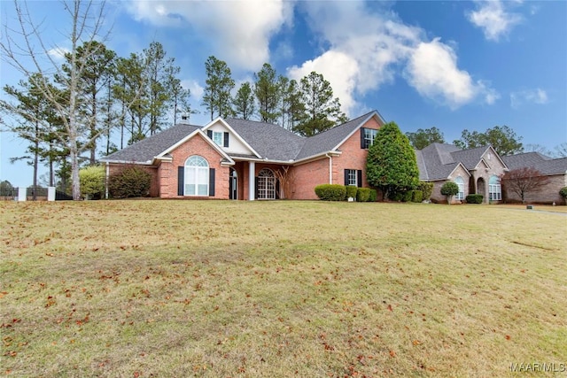 view of front of home with brick siding and a front yard