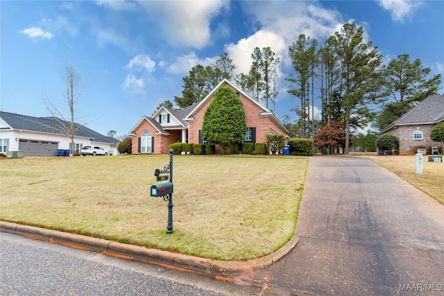 view of front of home with brick siding and a front lawn