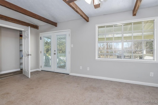 interior space with a ceiling fan, baseboards, lofted ceiling with beams, french doors, and a textured ceiling