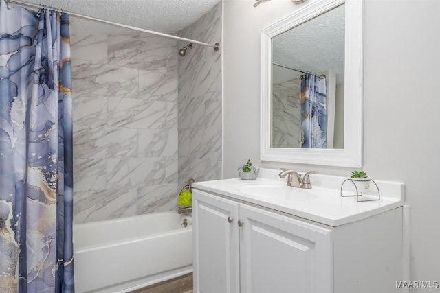 full bath with shower / bathtub combination with curtain, a textured ceiling, and vanity