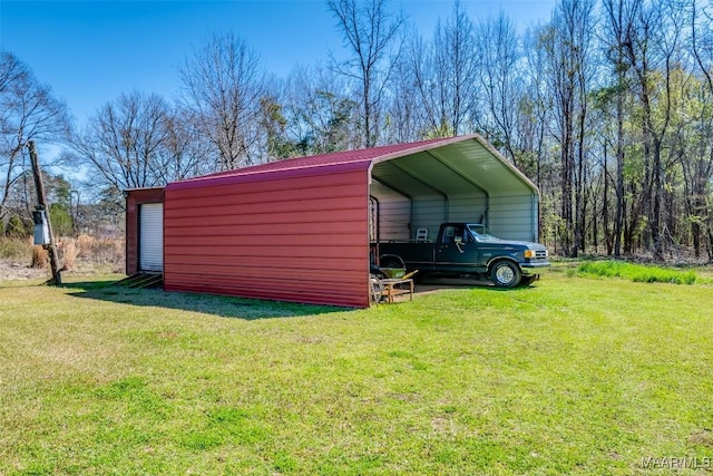 view of outdoor structure with a carport and driveway