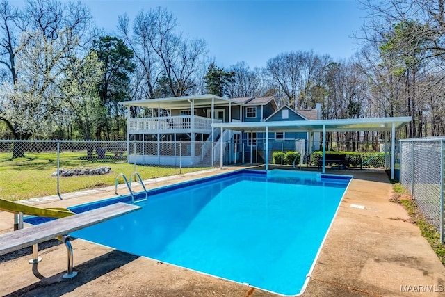 view of pool with a fenced backyard, a fenced in pool, a yard, and a diving board