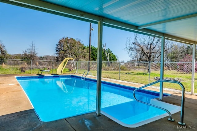 view of pool featuring a fenced in pool, a water slide, and a fenced backyard