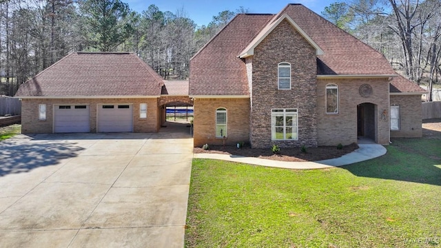 view of front of house featuring brick siding, an attached garage, concrete driveway, and a front lawn