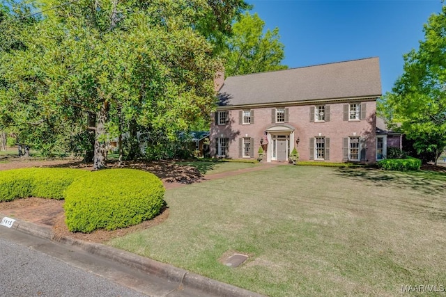 colonial home with a front lawn