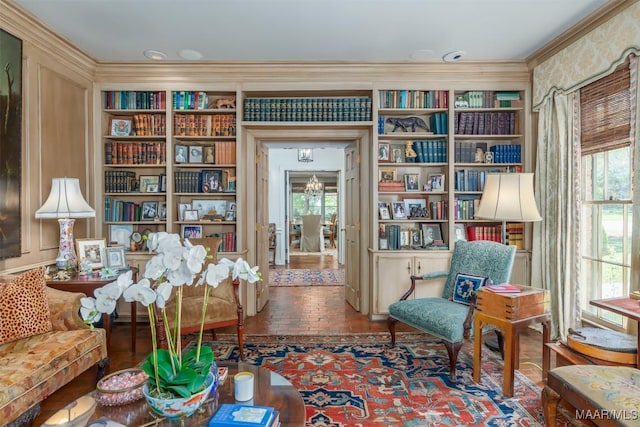 sitting room with a wealth of natural light, brick floor, and crown molding