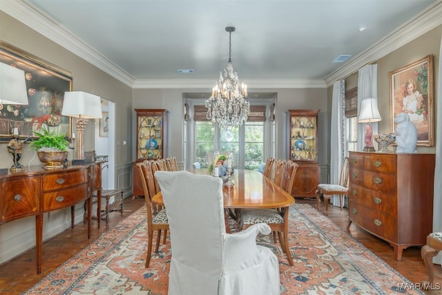 dining area featuring a chandelier, visible vents, and crown molding