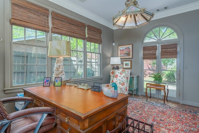 office area with visible vents, baseboards, and ornamental molding