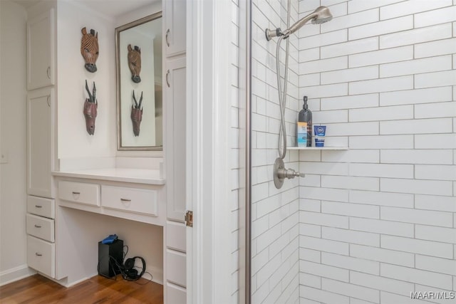 full bathroom with vanity, wood finished floors, and a shower stall