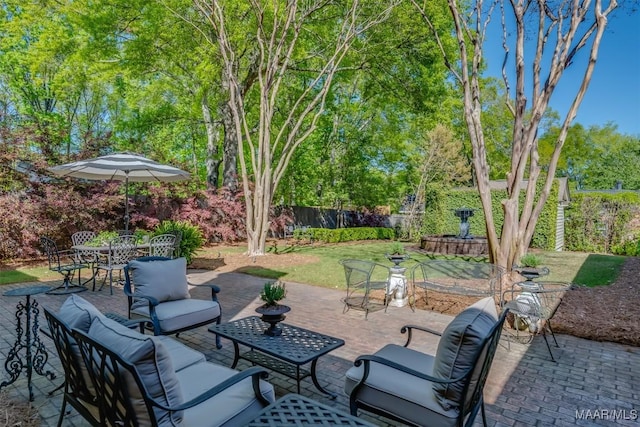 view of patio / terrace with an outdoor hangout area, outdoor dining area, and fence