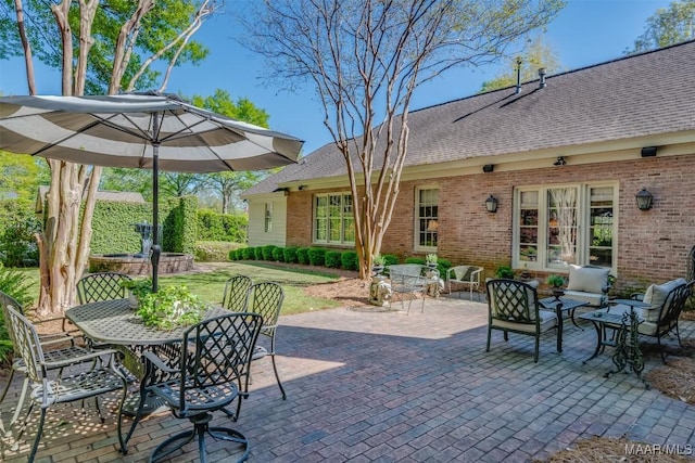 view of patio with outdoor dining space, an outdoor living space, and french doors