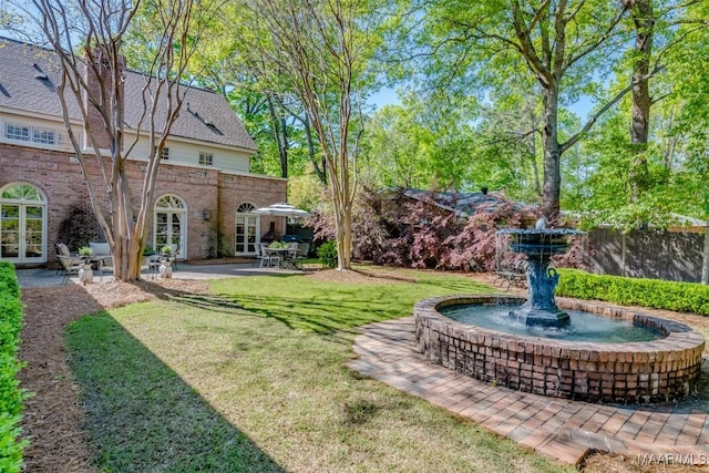 view of yard featuring french doors and a patio area