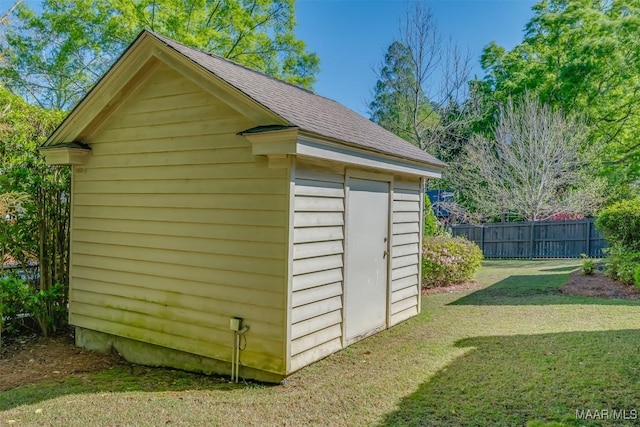 view of shed featuring fence