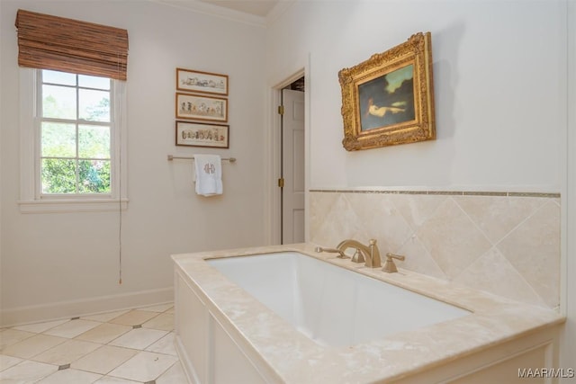 bathroom featuring tile patterned flooring, crown molding, baseboards, and a sink