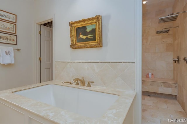 full bathroom with a sink, a bath, tile patterned floors, and a tile shower