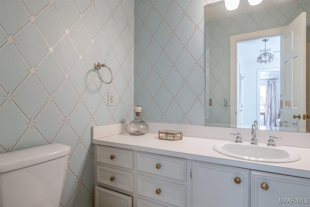 bathroom featuring toilet and vanity