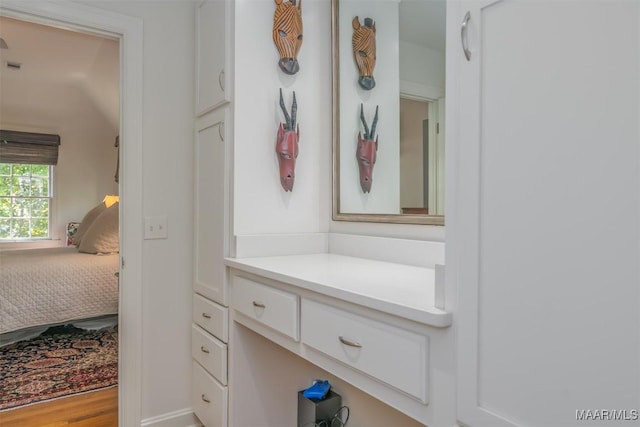 bathroom featuring ensuite bath and vanity