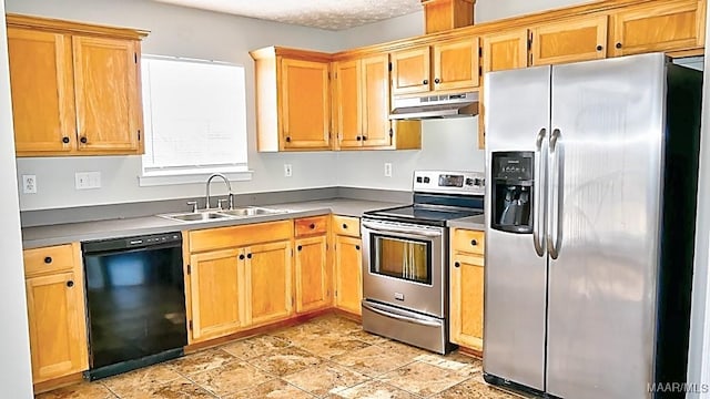 kitchen with under cabinet range hood, appliances with stainless steel finishes, and a sink