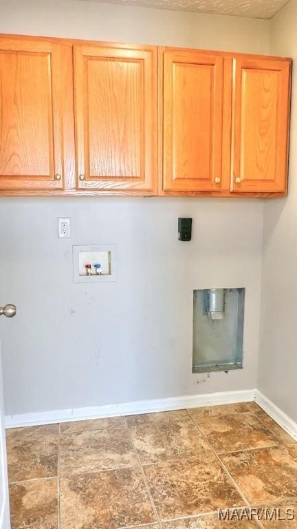 laundry room with washer hookup, cabinet space, and baseboards