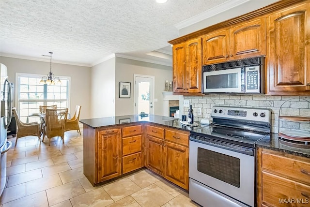 kitchen featuring tasteful backsplash, ornamental molding, brown cabinets, appliances with stainless steel finishes, and a peninsula