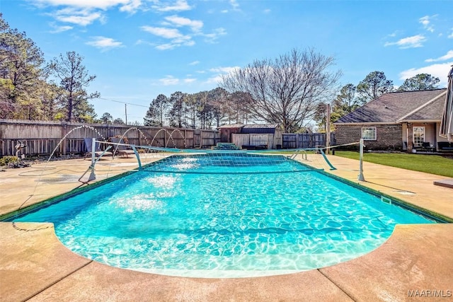 view of swimming pool with a patio area, a fenced in pool, and a fenced backyard