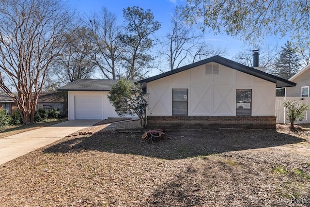 view of front of property featuring a garage, brick siding, and driveway