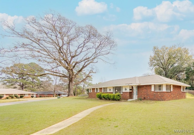 single story home with brick siding and a front yard