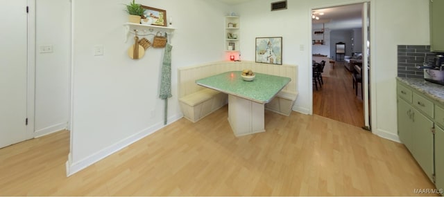 dining room with breakfast area, visible vents, baseboards, and light wood-style floors