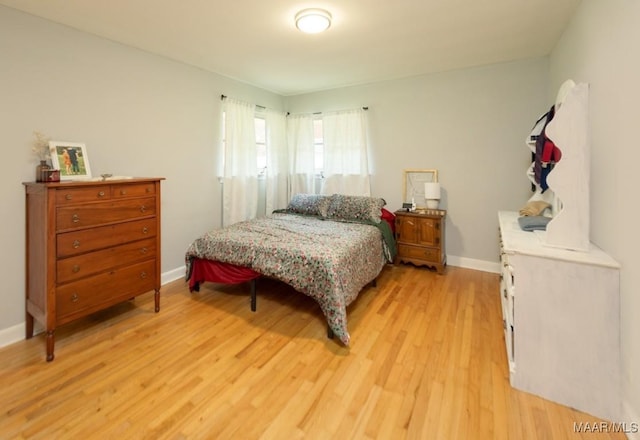 bedroom with baseboards and light wood-style floors