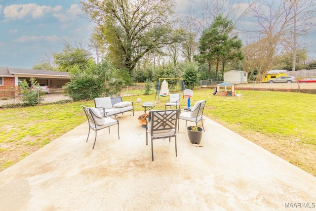 view of patio featuring a storage unit, an outdoor hangout area, an outdoor structure, and a fenced backyard